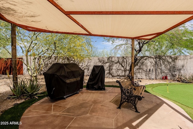 view of patio featuring a fenced backyard and a grill