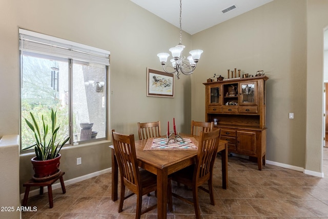 dining room with high vaulted ceiling, visible vents, a wealth of natural light, and an inviting chandelier