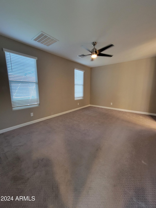 unfurnished room with ceiling fan and carpet