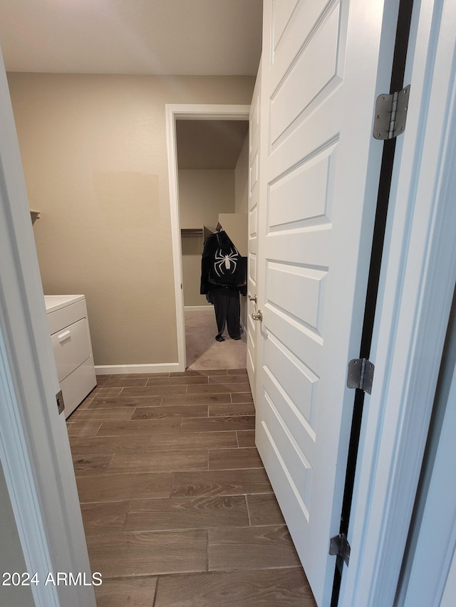 clothes washing area featuring dark wood-type flooring