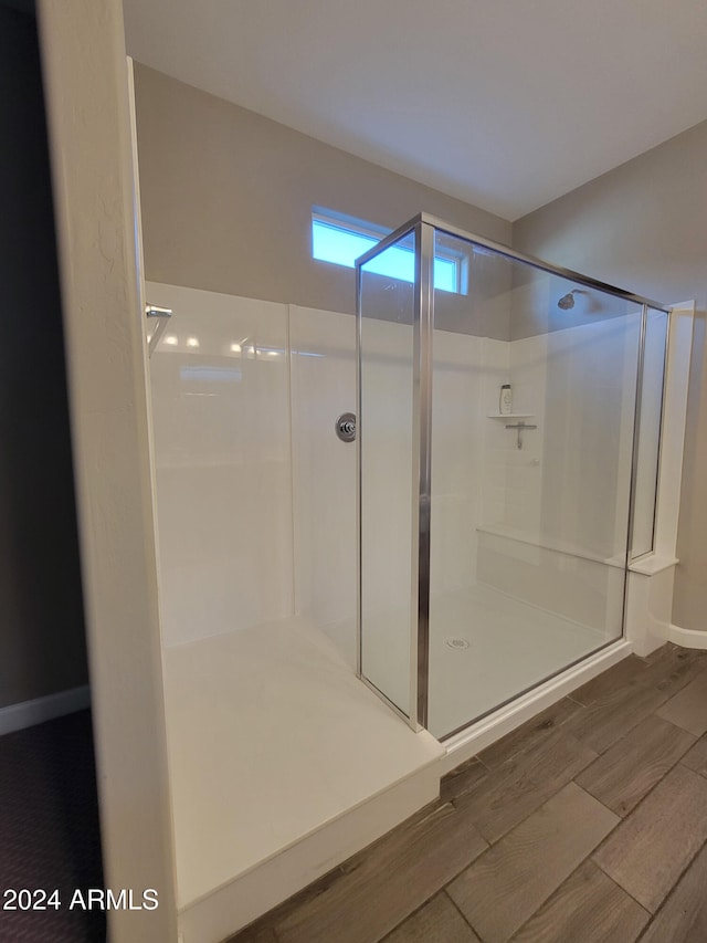 bathroom featuring a shower and hardwood / wood-style floors