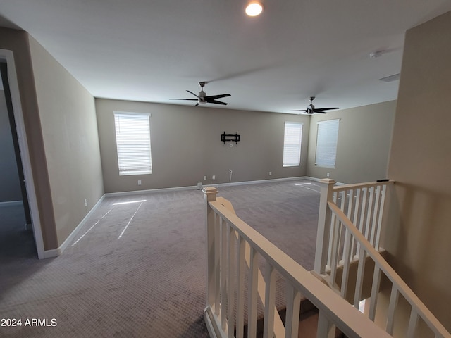 corridor featuring carpet floors and a wealth of natural light