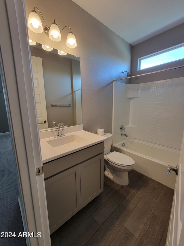 full bathroom with vanity, toilet, shower / bathing tub combination, and hardwood / wood-style flooring