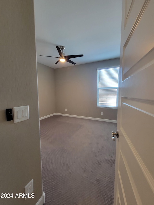 carpeted empty room with ceiling fan