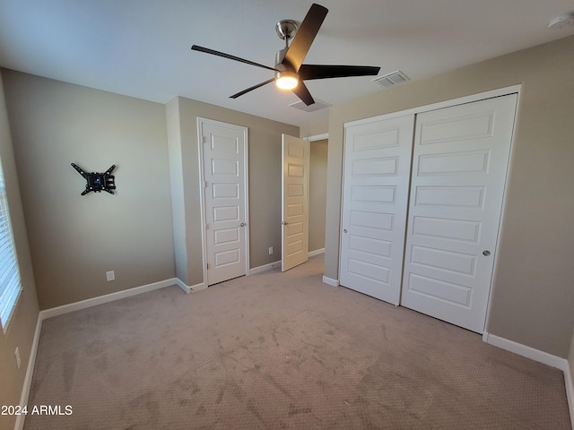 unfurnished bedroom with light colored carpet and ceiling fan