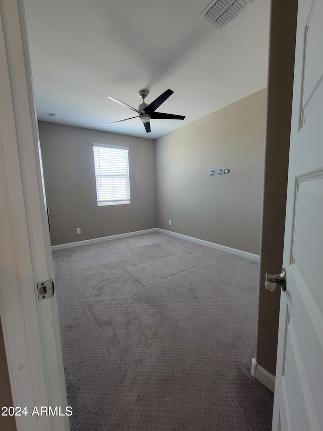 unfurnished room with ceiling fan and light colored carpet