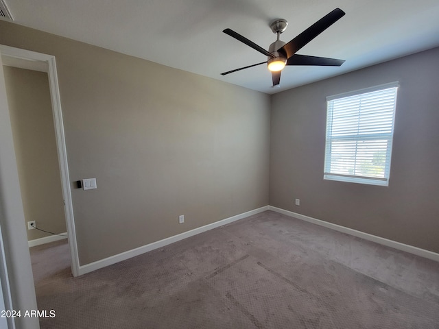 carpeted empty room featuring ceiling fan