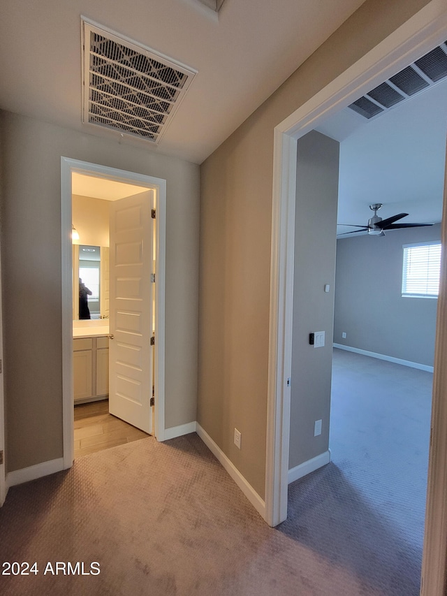 hallway featuring light carpet