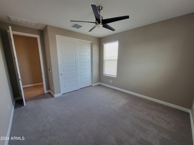 unfurnished bedroom with carpet flooring, a closet, and ceiling fan