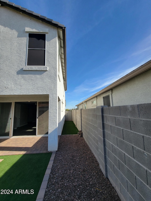 view of side of property with a patio area