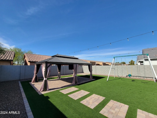 view of yard featuring a gazebo and a playground