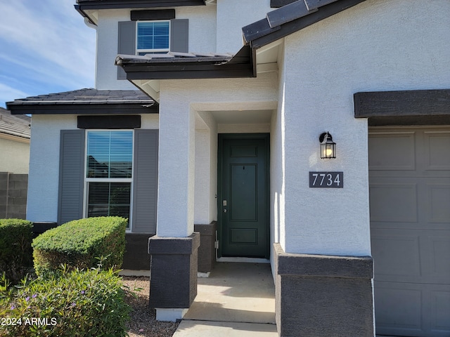 doorway to property with a garage