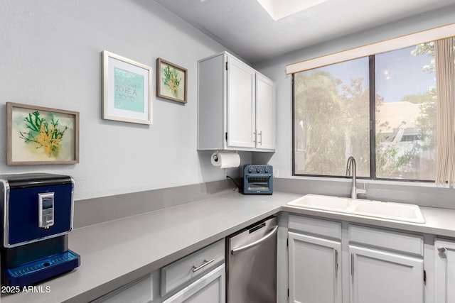 10863 N 117th Pl, Scottsdale, AZ 85259 - kitchen with stainless steel dishwasher, a sink, healthy amount of natural light, and light countertops