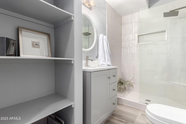 10863 N 117th Pl, Scottsdale, AZ 85259 - full bathroom featuring tiled shower, vanity, toilet, and wood finished floors