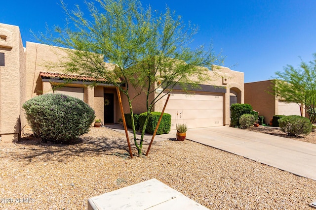 10863 N 117th Pl, Scottsdale, AZ 85259 - adobe home featuring concrete driveway, stucco siding, a tile roof, and an attached garage