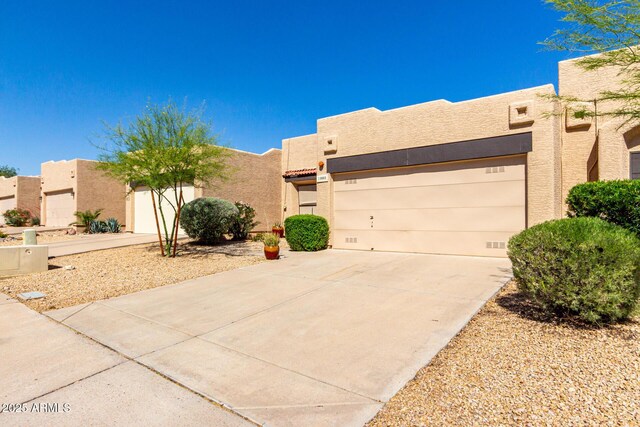 10863 N 117th Pl, Scottsdale, AZ 85259 - southwest-style home featuring concrete driveway, a garage, and stucco siding