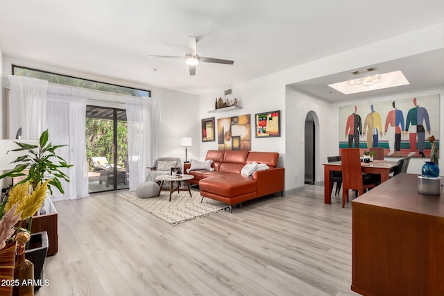 10863 N 117th Pl, Scottsdale, AZ 85259 - living room featuring arched walkways, wood finished floors, and ceiling fan
