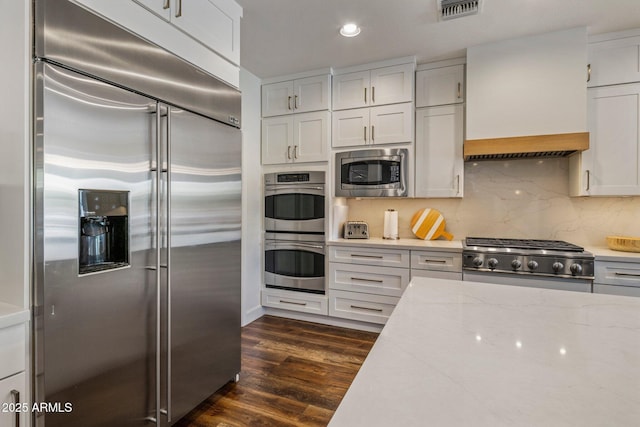 9904 E S Bend Dr, Scottsdale, AZ 85255 - kitchen with built in appliances, premium range hood, white cabinets, recessed lighting, and dark wood-style flooring