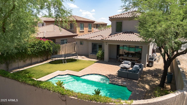 9904 E S Bend Dr, Scottsdale, AZ 85255 - back of house with a trampoline, stucco siding, a tile roof, a patio, and an outdoor living space