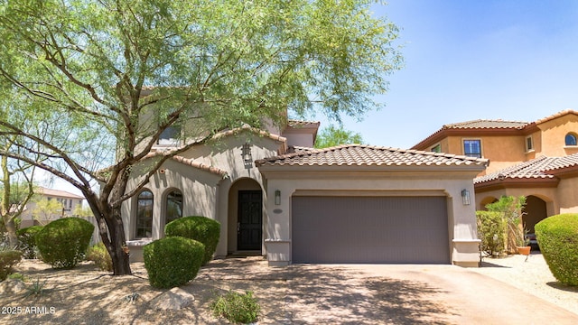 9904 E S Bend Dr, Scottsdale, AZ 85255 - mediterranean / spanish-style house with an attached garage, driveway, stucco siding, and a tiled roof