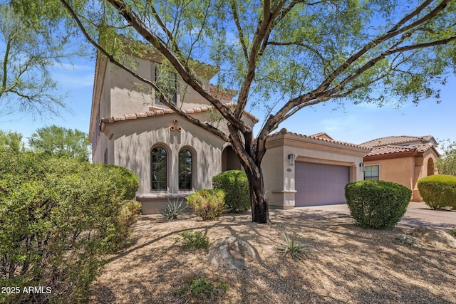9904 E S Bend Dr, Scottsdale, AZ 85255 - mediterranean / spanish house featuring an attached garage, a tile roof, stucco siding, and driveway