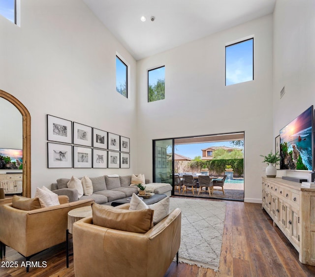 9904 E S Bend Dr, Scottsdale, AZ 85255 - living area featuring a high ceiling, healthy amount of natural light, dark wood-style floors, and baseboards