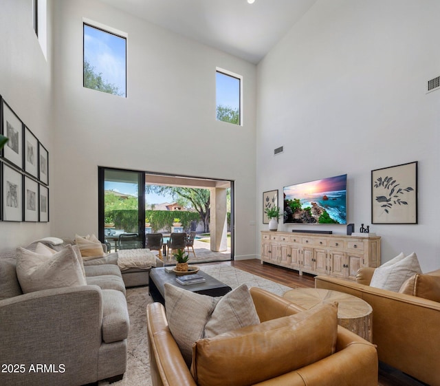 9904 E S Bend Dr, Scottsdale, AZ 85255 - living area featuring a towering ceiling, wood finished floors, plenty of natural light, and baseboards