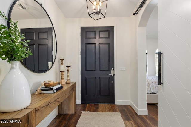 9904 E S Bend Dr, Scottsdale, AZ 85255 - entryway featuring arched walkways, dark wood-style flooring, baseboards, and a chandelier