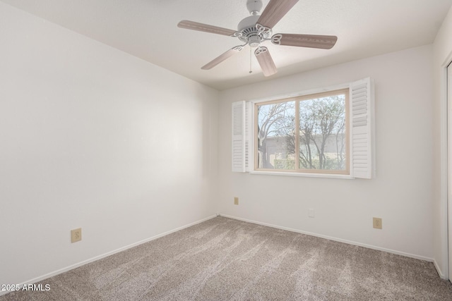 carpeted empty room featuring ceiling fan