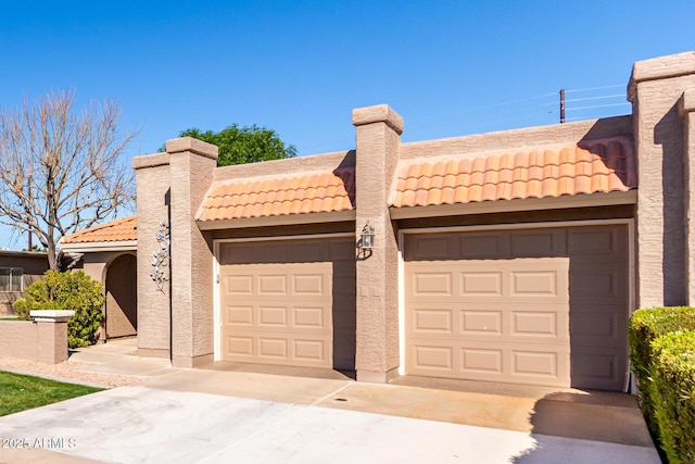 pueblo revival-style home with a garage