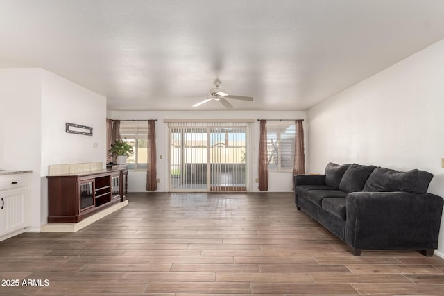 living room featuring wood-type flooring and ceiling fan