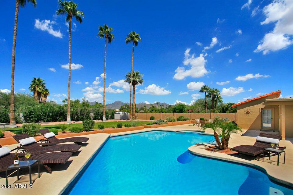 view of pool featuring a mountain view and a patio area