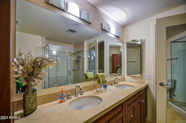 bathroom with tile patterned flooring, vanity, and a shower with shower door