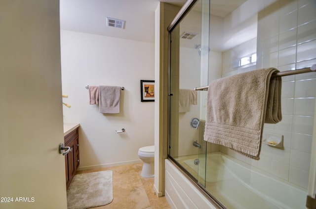 full bathroom with tile patterned flooring, vanity, toilet, and bath / shower combo with glass door