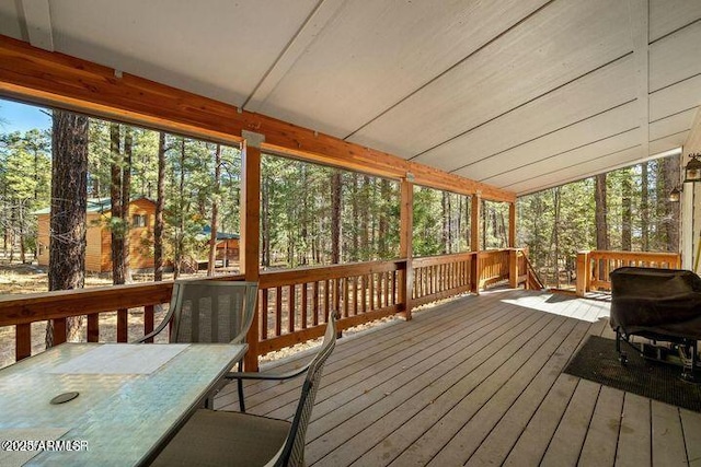 unfurnished sunroom with lofted ceiling