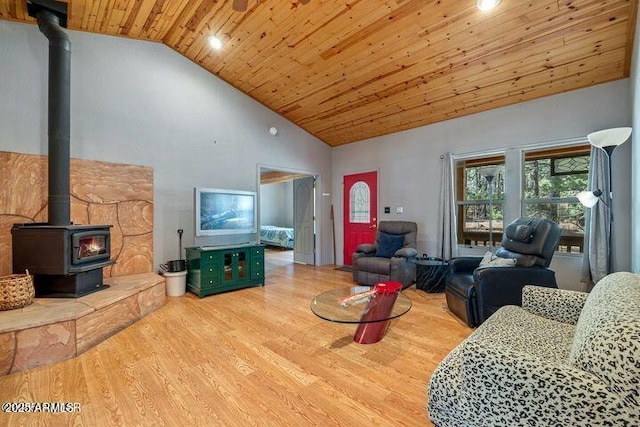 living room featuring wooden ceiling, high vaulted ceiling, a wood stove, and wood finished floors