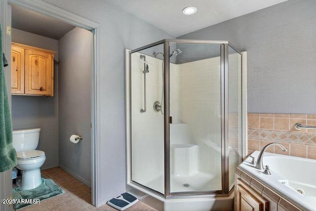 bathroom featuring toilet, a shower stall, a garden tub, and tile patterned floors