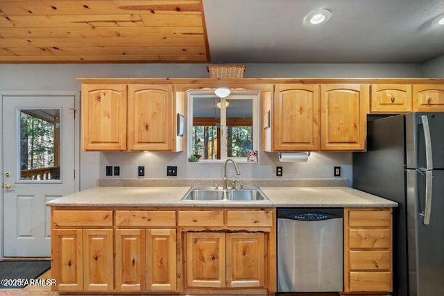 kitchen featuring a sink, stainless steel dishwasher, a wealth of natural light, and freestanding refrigerator