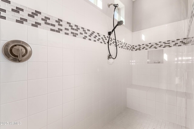 interior details featuring tiled shower