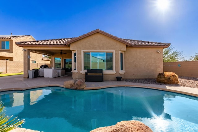 view of pool with ceiling fan and a patio area