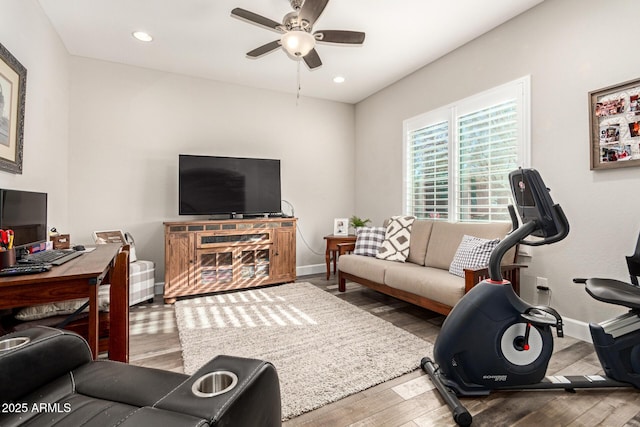 living room featuring hardwood / wood-style flooring and ceiling fan