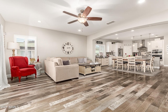 living room with hardwood / wood-style floors and ceiling fan