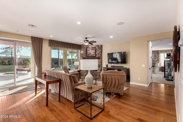 living room with ceiling fan and wood-type flooring