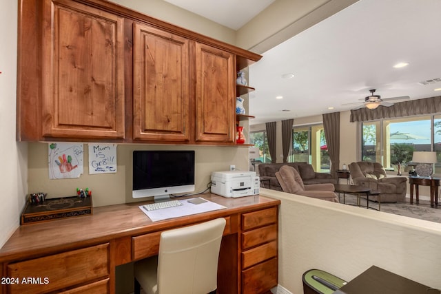 office space with ceiling fan and built in desk