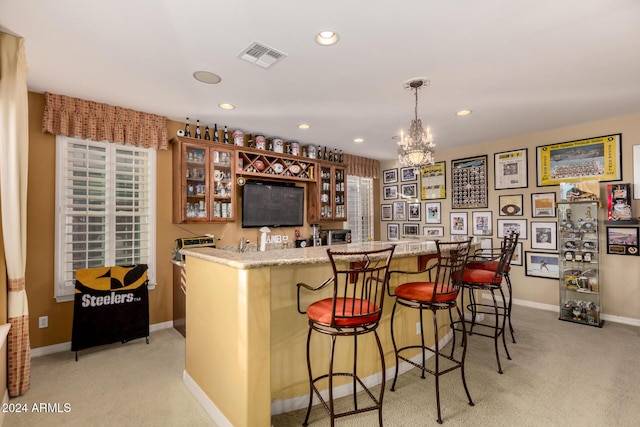 bar with a chandelier, light colored carpet, and decorative light fixtures