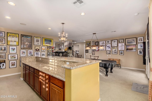 kitchen featuring light carpet, decorative light fixtures, light stone countertops, and billiards