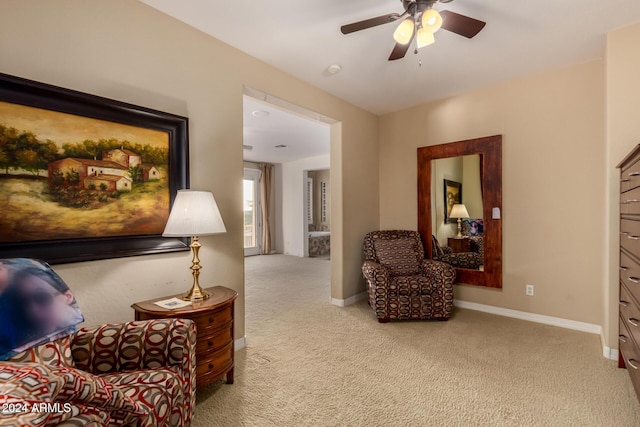 sitting room featuring ceiling fan and light colored carpet