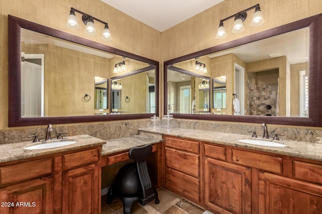 bathroom featuring vanity, plenty of natural light, and walk in shower