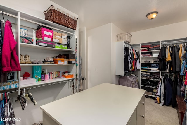 walk in closet featuring light carpet