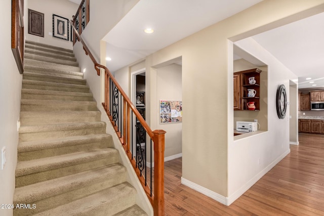 stairway featuring hardwood / wood-style flooring